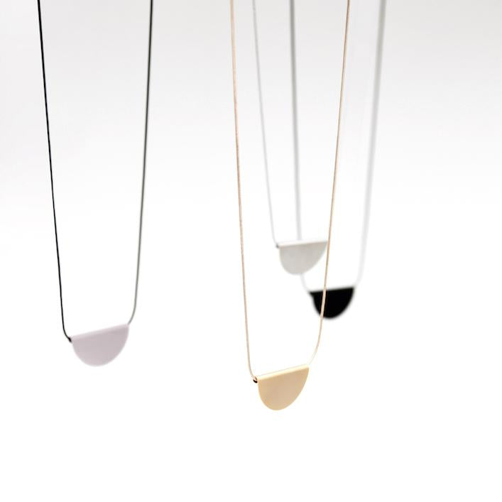 The half moon pendant of these long necklace hangs gently on a sleek snake chain. 