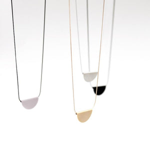 
                  
                    The half moon pendant of these long necklace hangs gently on a sleek snake chain. 
                  
                