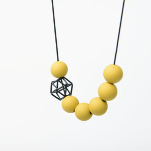 
                  
                    This classy and bold piece is one of our most popular designs. Here a combination of bright dijon yellow orb beads and a black hexagon charm adds a charming pop of colour and personality!
                  
                