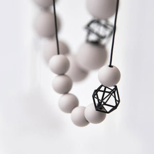 
                  
                    This classy and bold piece is one of our most popular designs. Here a combination of pink blush orb beads and a black hexagon charm makes for a soft and delicate necklace  
                  
                