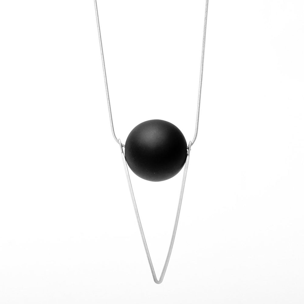 
                  
                    The minimal design of the sleek triangular pendant with the solidity and weight of the orb bead is what makes this necklace so special.
                  
                
