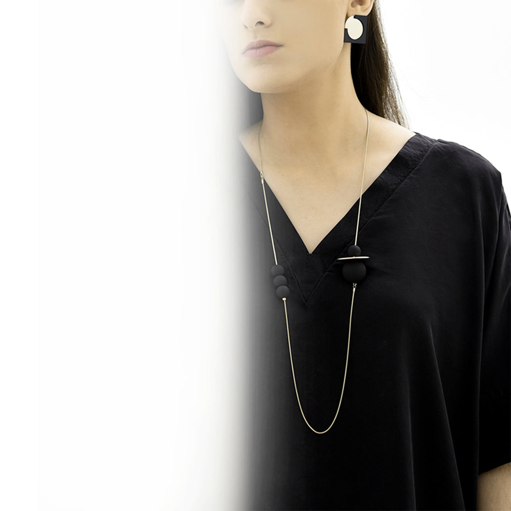 
                  
                    This balanced and modern geometric necklace is easy to wear and is an elegant statement piece.
                  
                