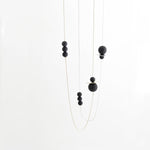 This balanced and modern geometric necklace is easy to wear and is an elegant statement piece