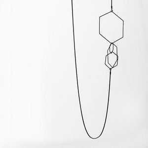 
                  
                    This delicate hexagon pendant hangs lightly on the body and can be worn in a couple different ways.
                  
                