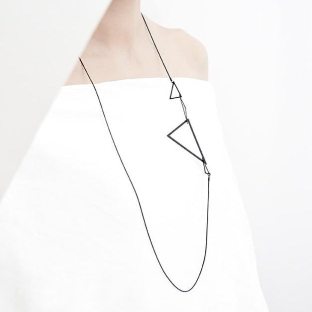 The minimal geometric triangles of this long necklace are lightweight and delicate. This is one of our most popular designs and makes a stylish addition to any outfit!