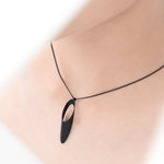 This delicate oblong slice is a eye-catching short necklace hanging on a thin curb chain.