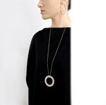This bold circle pendant is a statement piece. Each round ring has matte finish in gold, silver, or black.
