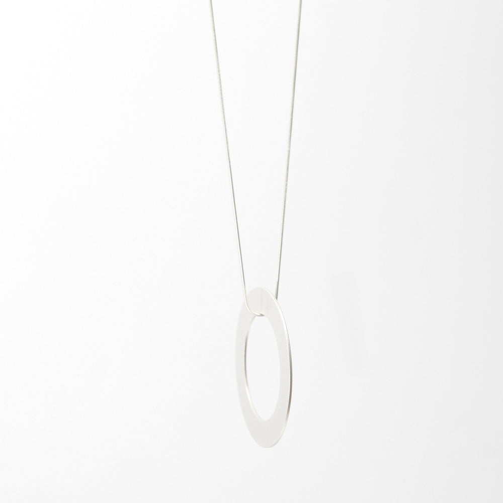 
                  
                    This bold circle pendant is a statement piece. Each round ring has matte finish in gold, silver, or black.
                  
                