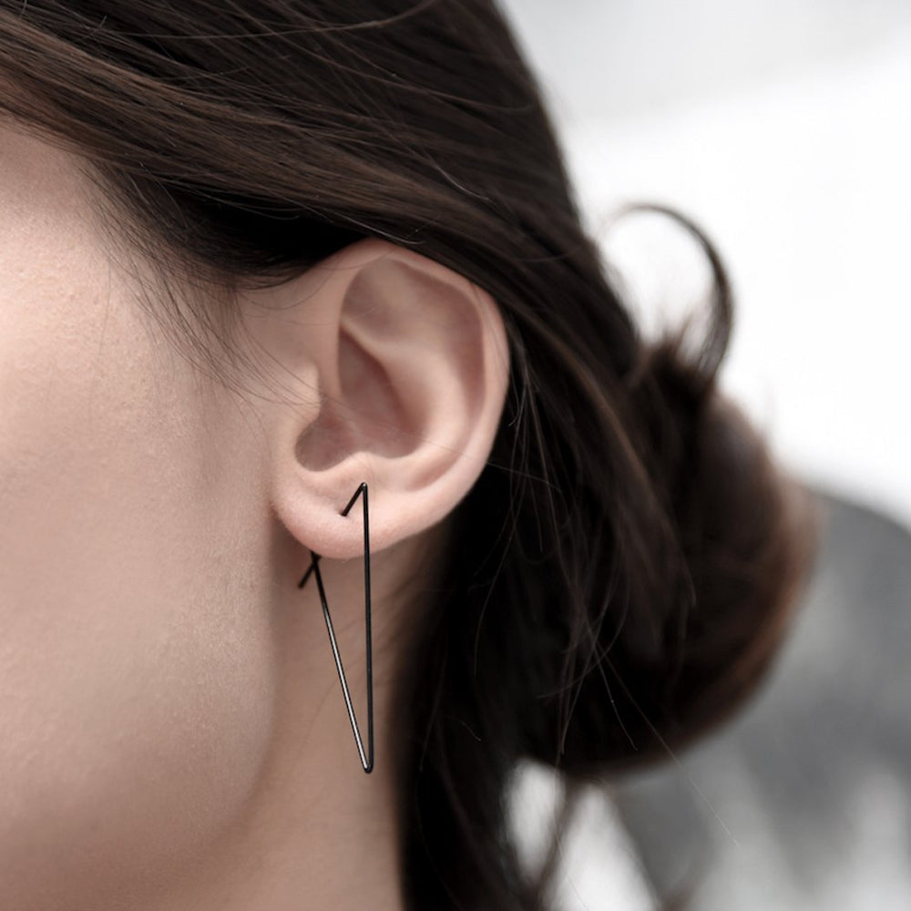
                  
                    A minimal and sleek set of triangular geometric hoop earrings
                  
                