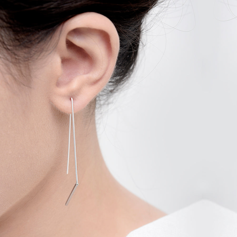 
                  
                    These simple angled hoops are a popular and minimal design.
                  
                