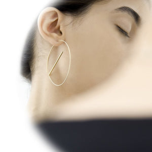 
                  
                    A lightweight and dynamic pair of earrings. These ear hoops are designed to float below the ear, a delicate statement pair the comes in gold, silver, and black as well as dual-tones.
                  
                